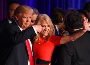 Republican presidential candidate Donald Trump falnked by campaign manager Kellyanne Conway waves to supporters following an address during election night at the New York Hilton Midtown in New York on November 9, 2016.  Trump won the US presidency. / AFP / Timothy A. CLARY